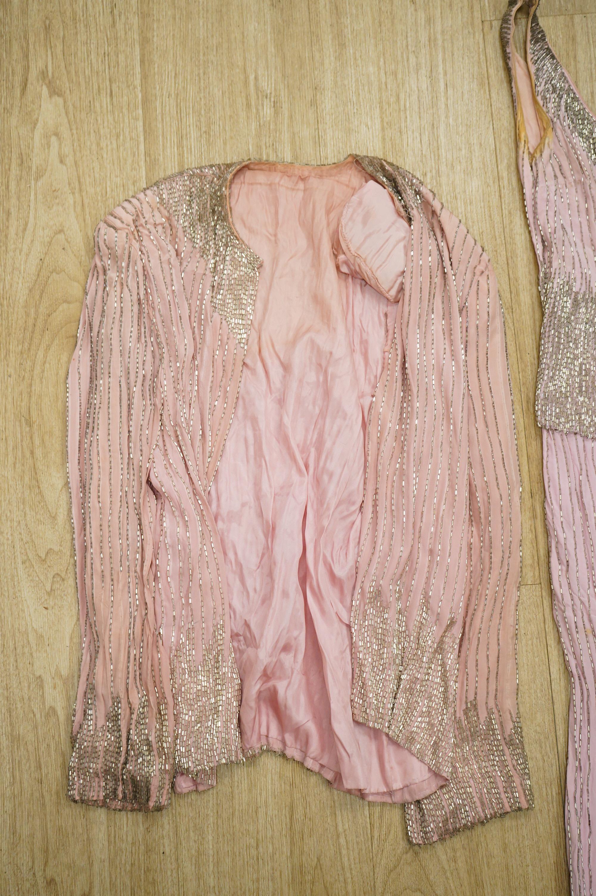 A mid to late 20th century pink and silver beaded evening dress-120cm long, with matching jacket, together with a green net beaded full length evening dress with mushroom lining and back split.
